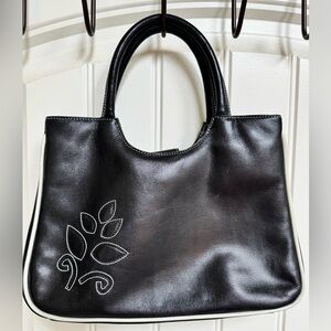 Jane Shilton Black and Cream Floral Leather Handbag. 11” by 8” by 3.5”